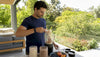 Man preparing mixed protein powder shake at home kitchen