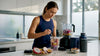 Woman preparing exotic protein shake in kitchen