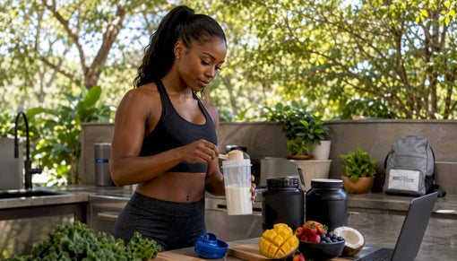 Fit Black woman mixing protein shake in kitchen