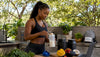 Fit Black woman mixing protein shake in kitchen