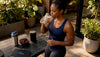 Fit black woman drinking meal replacement shake