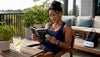 Woman reading appetite supplement brochure at kitchen counter