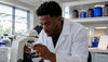 Scientist adjusting fat cell slide in lab