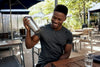 Black man shaking protein shaker cup