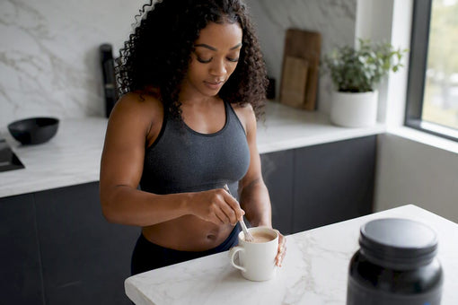 Fit Black woman whisking protein powder into hot coffee
