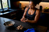 Black woman rolling no-bake protein balls