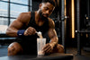 Black athlete measuring pre-workout powder