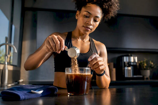 Fit Black woman preparing protein coffee