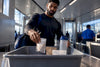 Black traveler placing protein portions in security tray