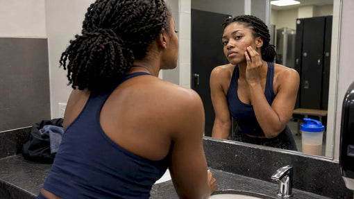 Athlete checks her skin beside a shaker